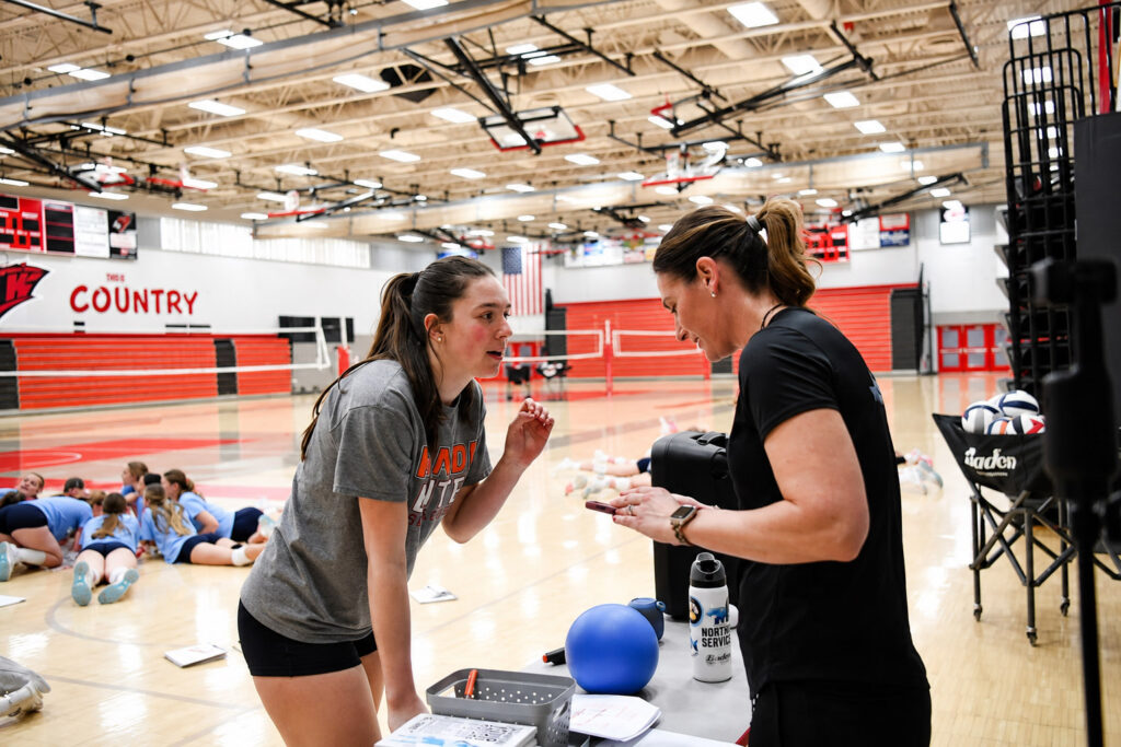 Cathy Helin guiding volleyball player during practice, emphasizing structured mindset coaching, communication, and consistent performance development.
