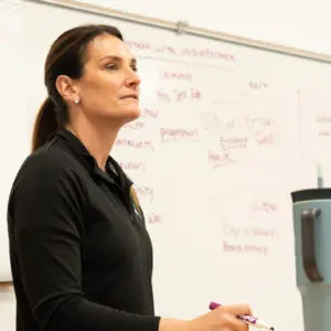 Coach teaches athlete mindset strategies during workshop while representing Bearcat Coaching with practical performance lessons for everyone today.