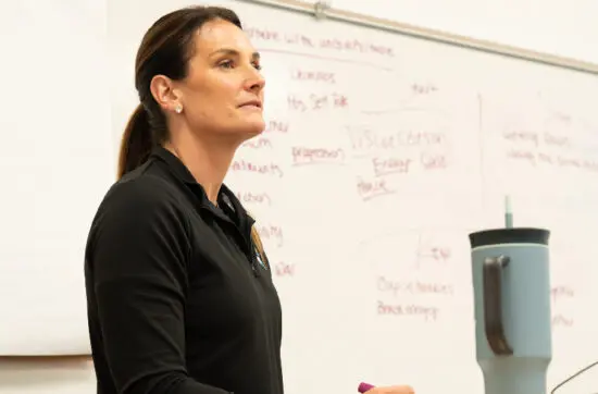 Coach teaches athlete mindset strategies during workshop while representing Bearcat Coaching with practical performance lessons for everyone today.