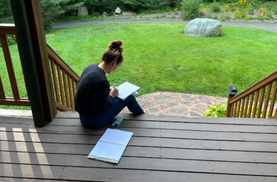 Cathy journals outdoors while developing confidence and resilience with Bearcat Coaching personal growth techniques every single day consistently.