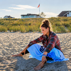 Cathy reflects peacefully on the beach while building mental resilience through Bearcat Coaching guidance and personal growth daily.
