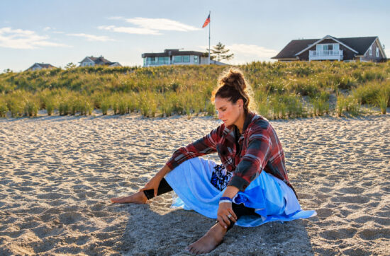 Cathy reflects peacefully on the beach while building mental resilience through Bearcat Coaching guidance and personal growth daily.