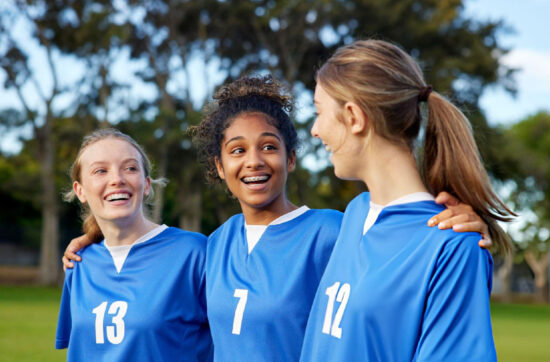 Young teammates celebrate friendship and confidence while embracing Bearcat Coaching values for teamwork, resilience, and lasting athletic success together.