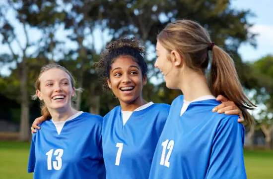 Young teammates celebrate friendship and confidence while embracing Bearcat Coaching values for teamwork, resilience, and lasting athletic success together.