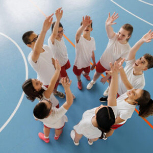 Basketball teammates unite before competition while strengthening teamwork through Bearcat Coaching leadership and mindset development together always.
