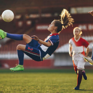Football athlete demonstrates determination during competition while applying Bearcat Coaching mental performance strategies for success on field.