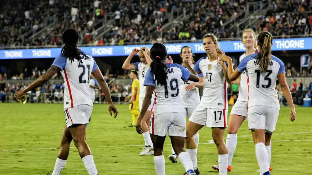 Young soccer athletes celebrating together after a match, demonstrating teamwork, confidence, and positive team spirit success.