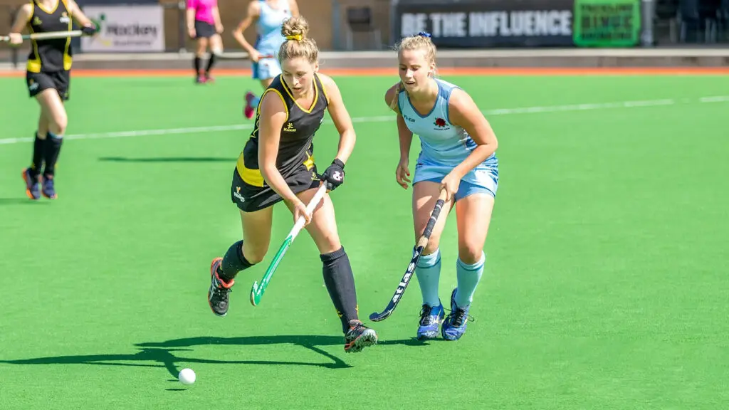 Young hockey athletes competing on field while building confidence, teamwork, and mental strength through youth sports.